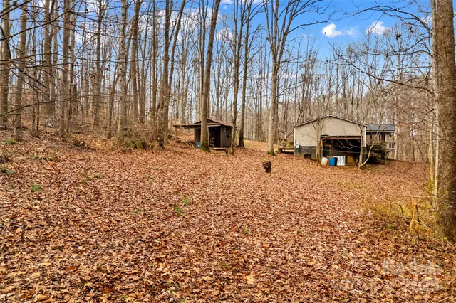 a bedroom with a bed a couch and a chandelier