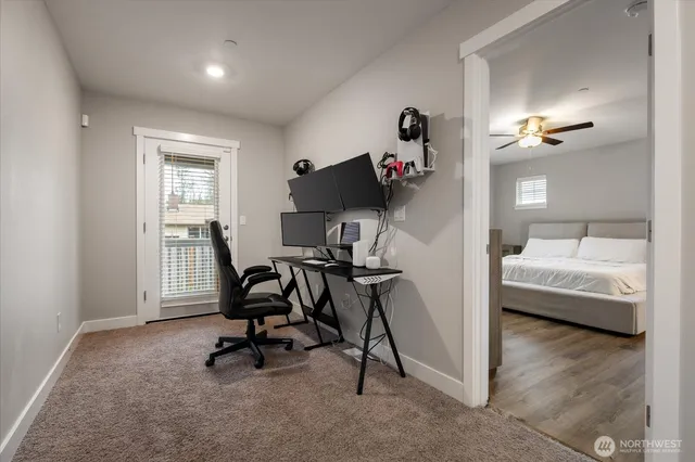 a view of a workspace with furniture and a window