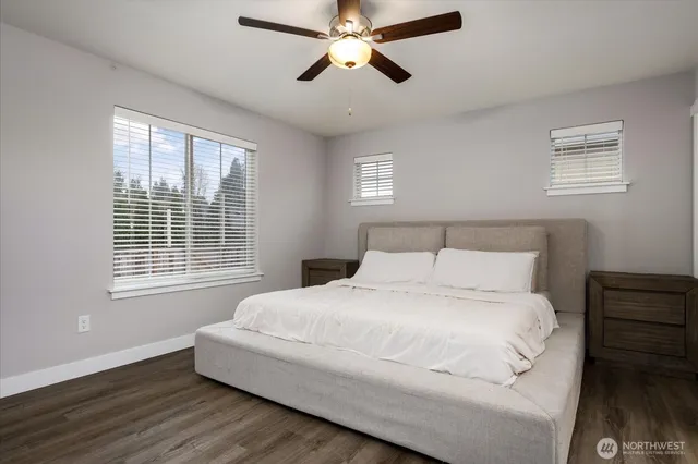 a bedroom with a bed and wooden floor