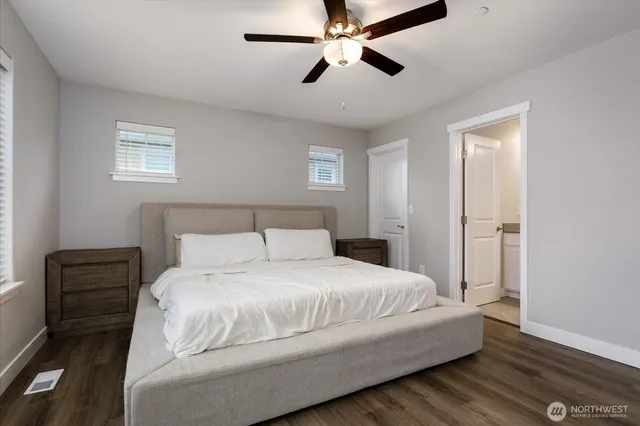 a bedroom with a bed and wooden floor