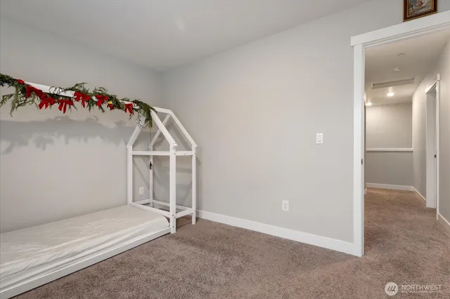 an empty room with white walls and stairs