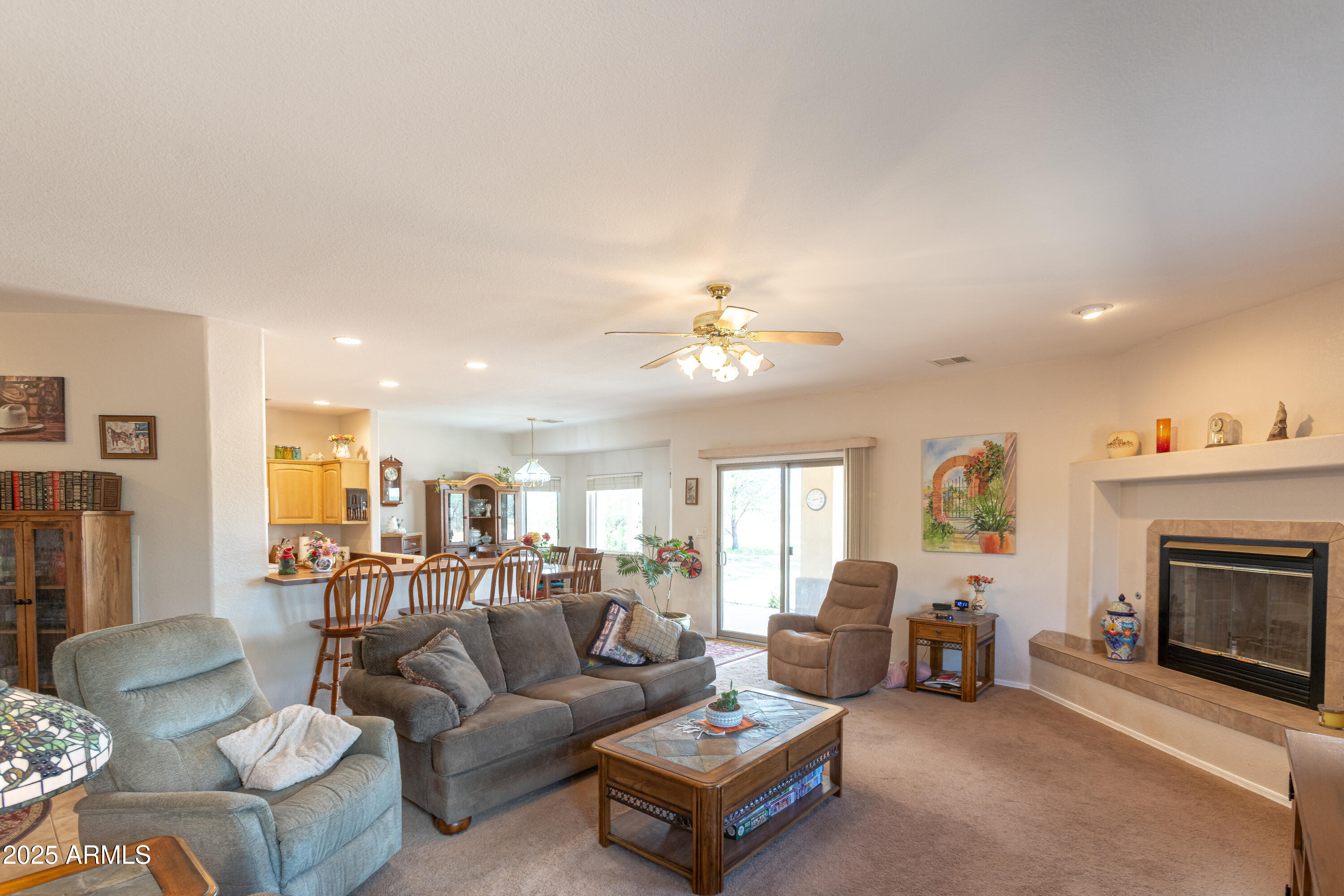 7072 South Ridling Drive Hereford, AZ 85615 - Photo 17 of 69 a living room with furniture kitchen view and a fireplace