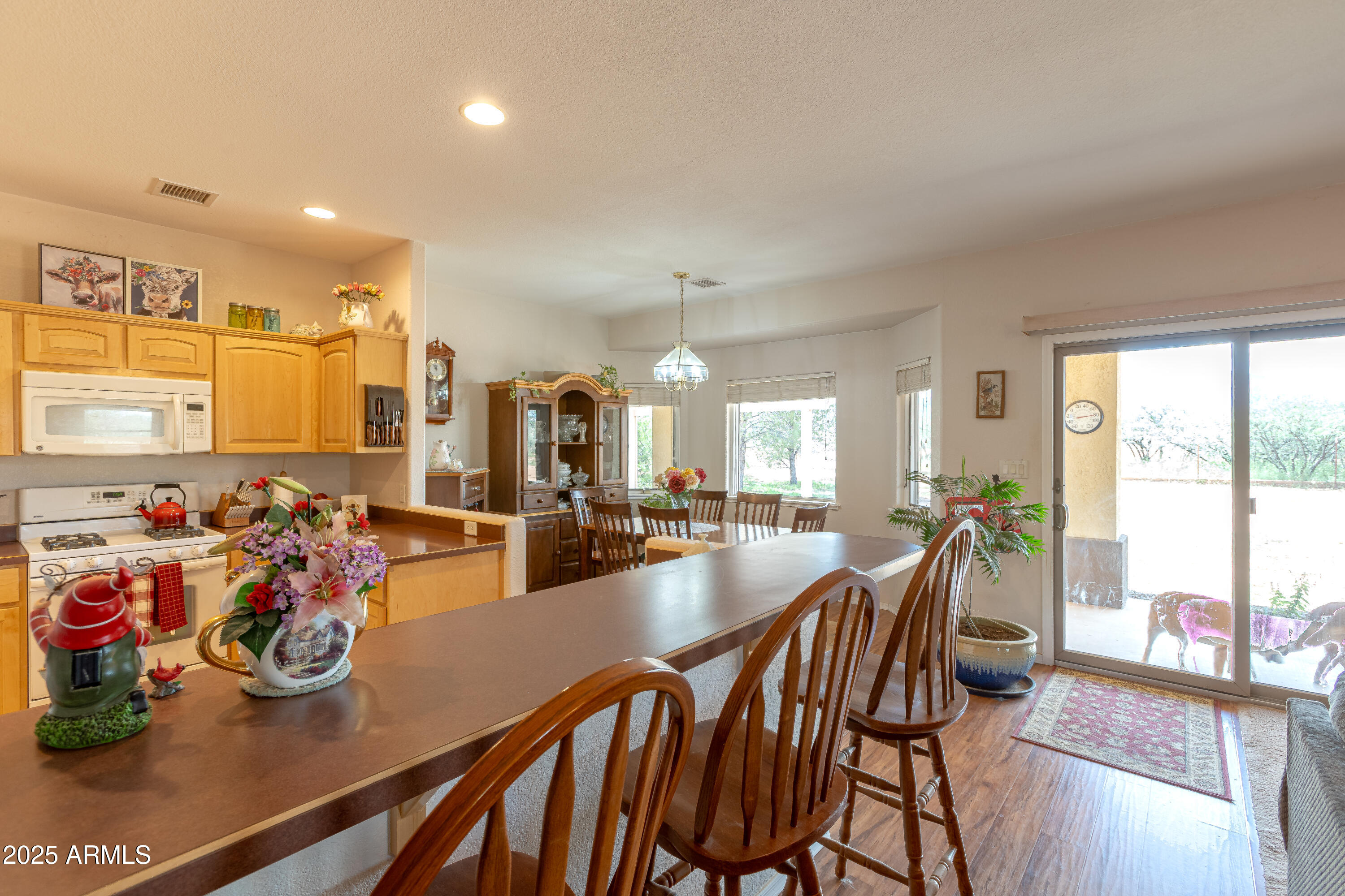 7072 South Ridling Drive Hereford, AZ 85615 - Photo 20 of 69 a view of a dining room with furniture one side kitchen view and wooden floor