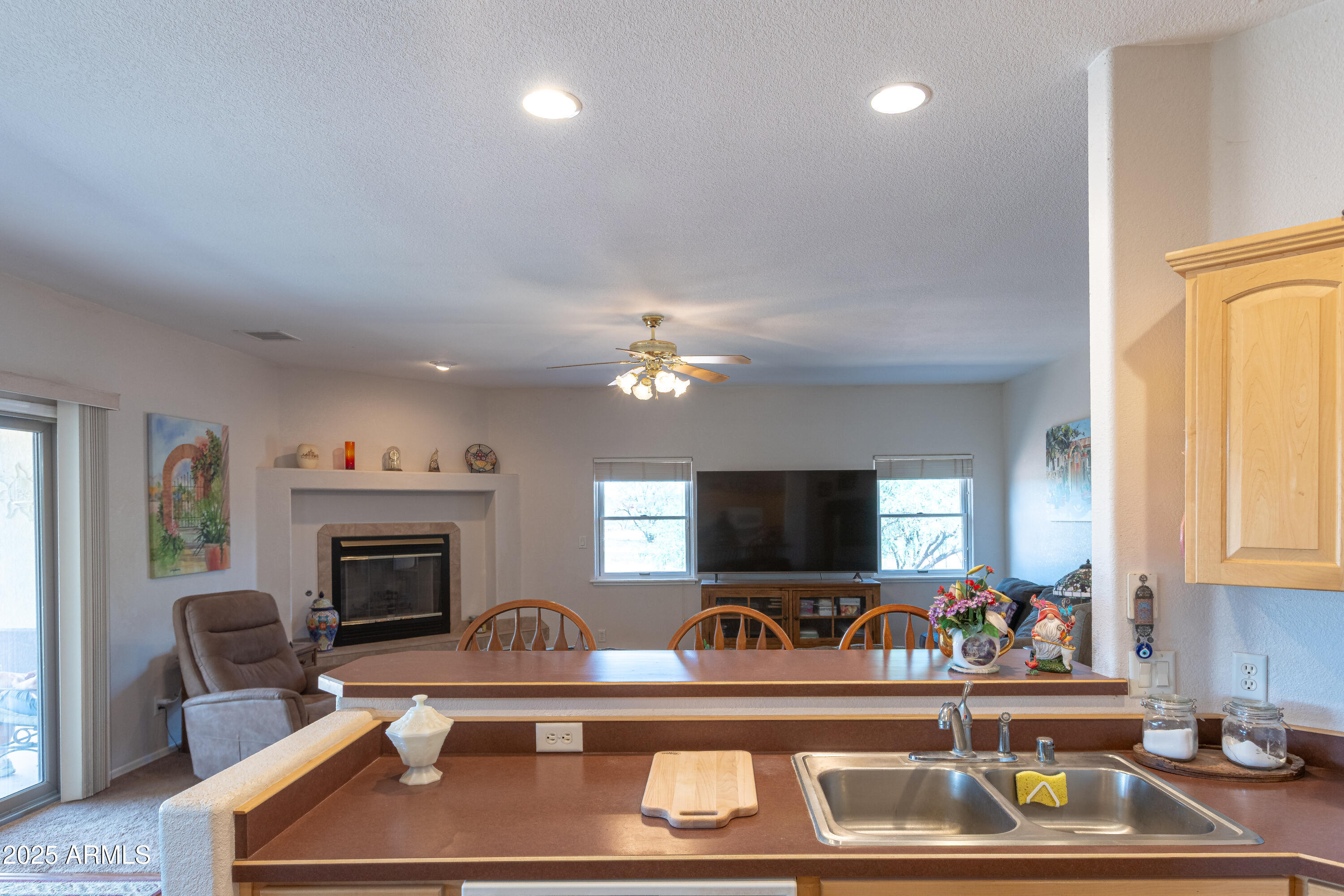 7072 South Ridling Drive Hereford, AZ 85615 - Photo 22 of 69 a living room with furniture a flat screen tv and a fireplace