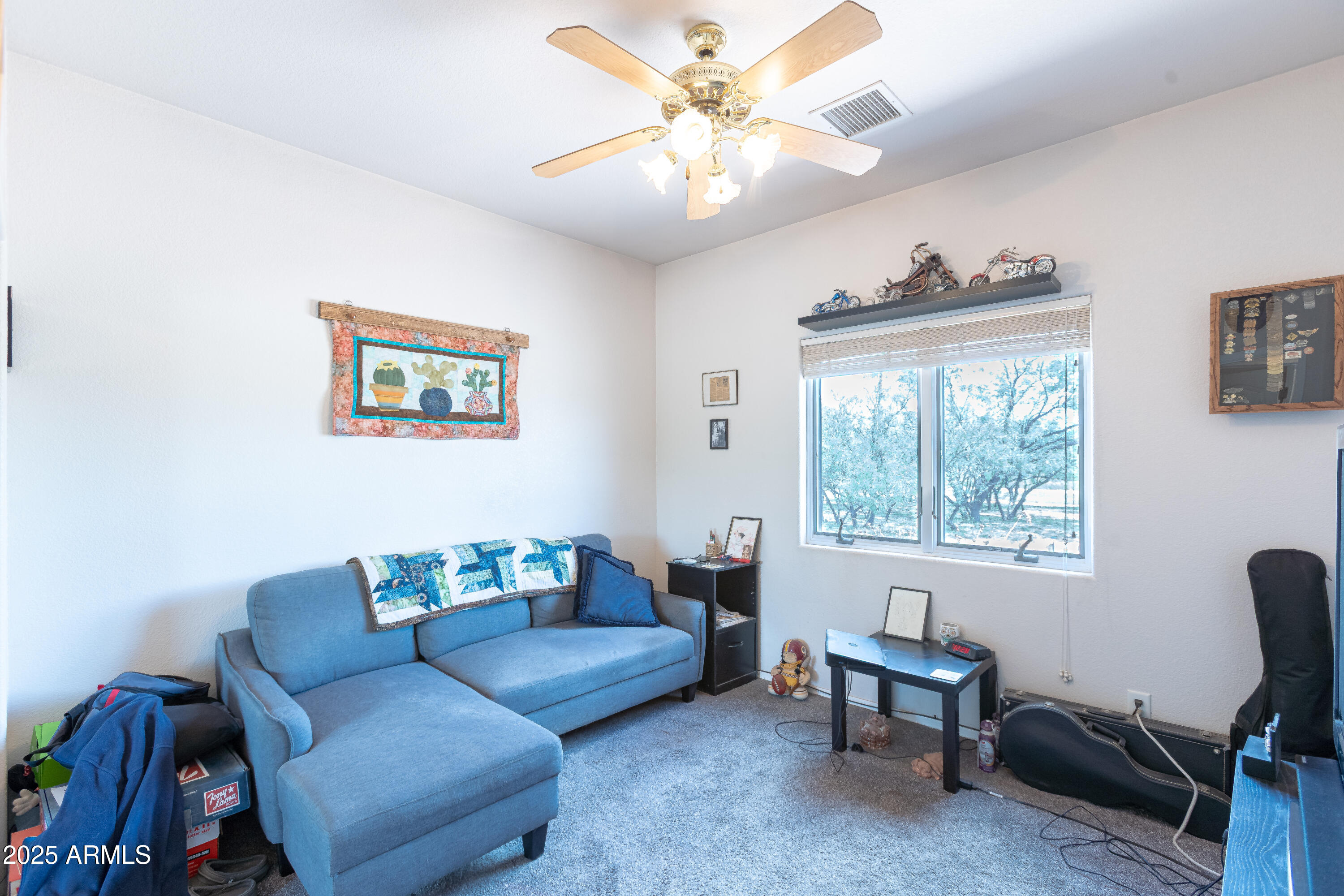 7072 South Ridling Drive Hereford, AZ 85615 - Photo 30 of 69 a living room with furniture a chandelier and a window