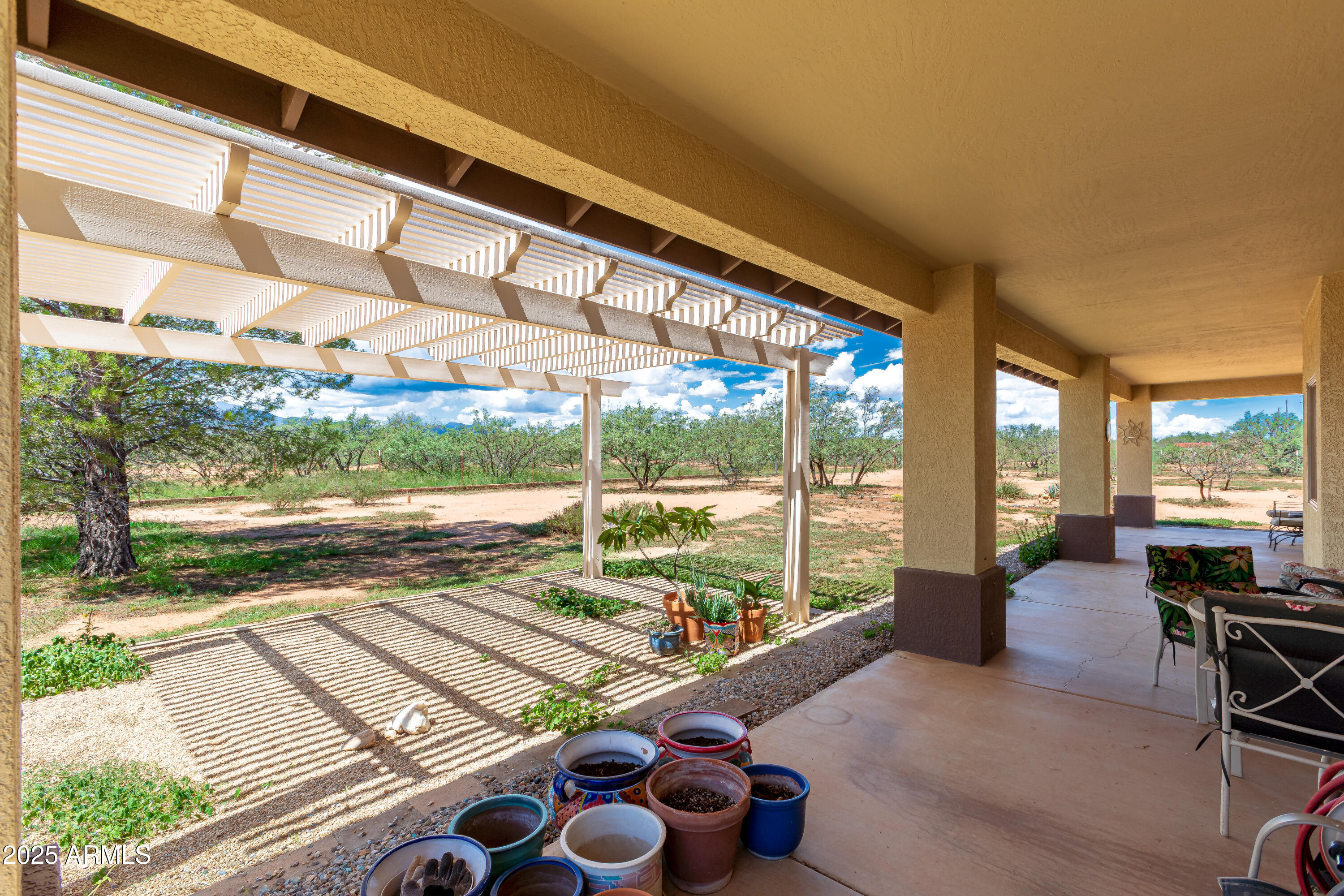 7072 South Ridling Drive Hereford, AZ 85615 - Photo 47 of 69 a living room with a floor to ceiling window next to a yard