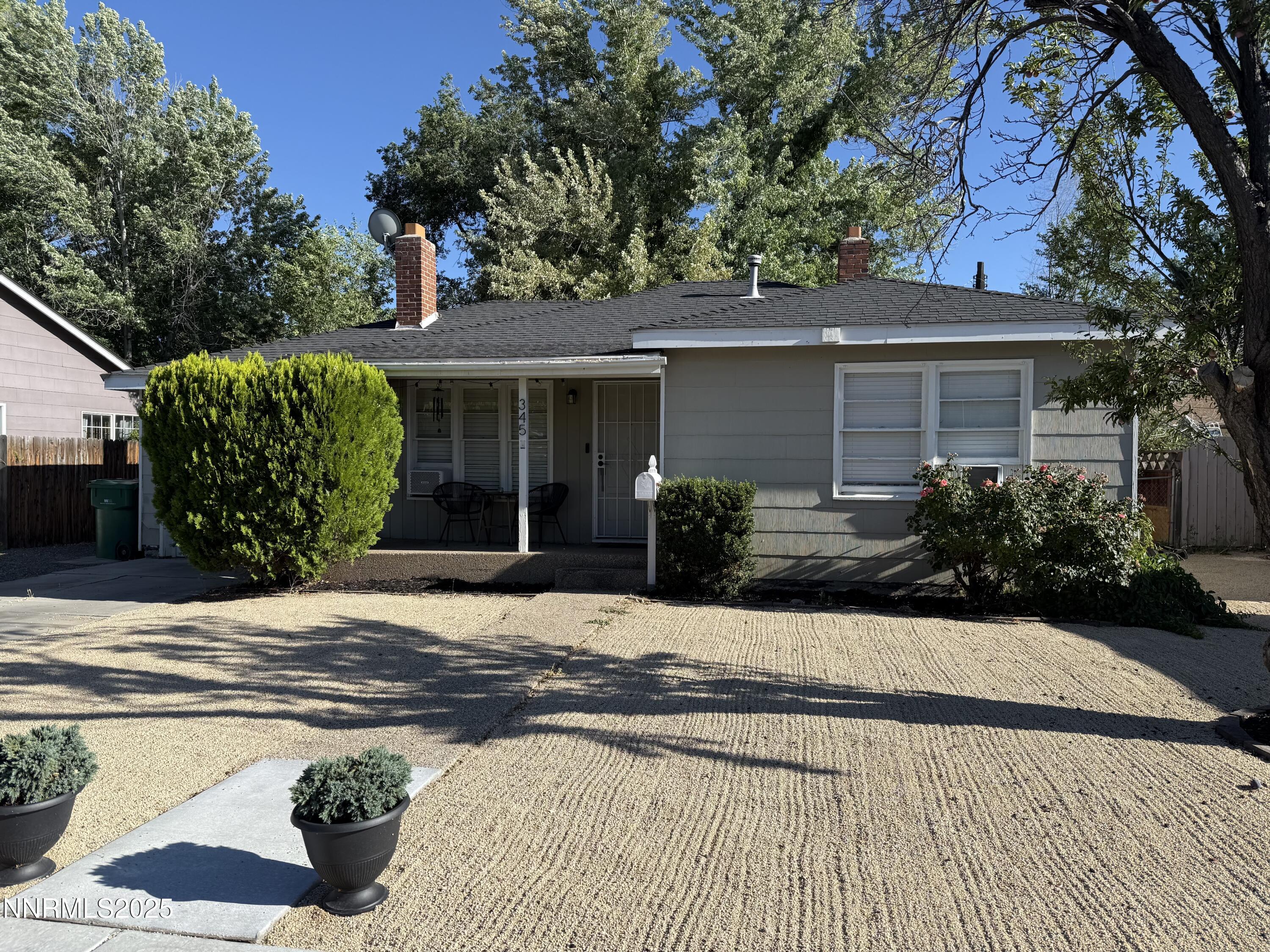 a view of a house with a tree in front of it