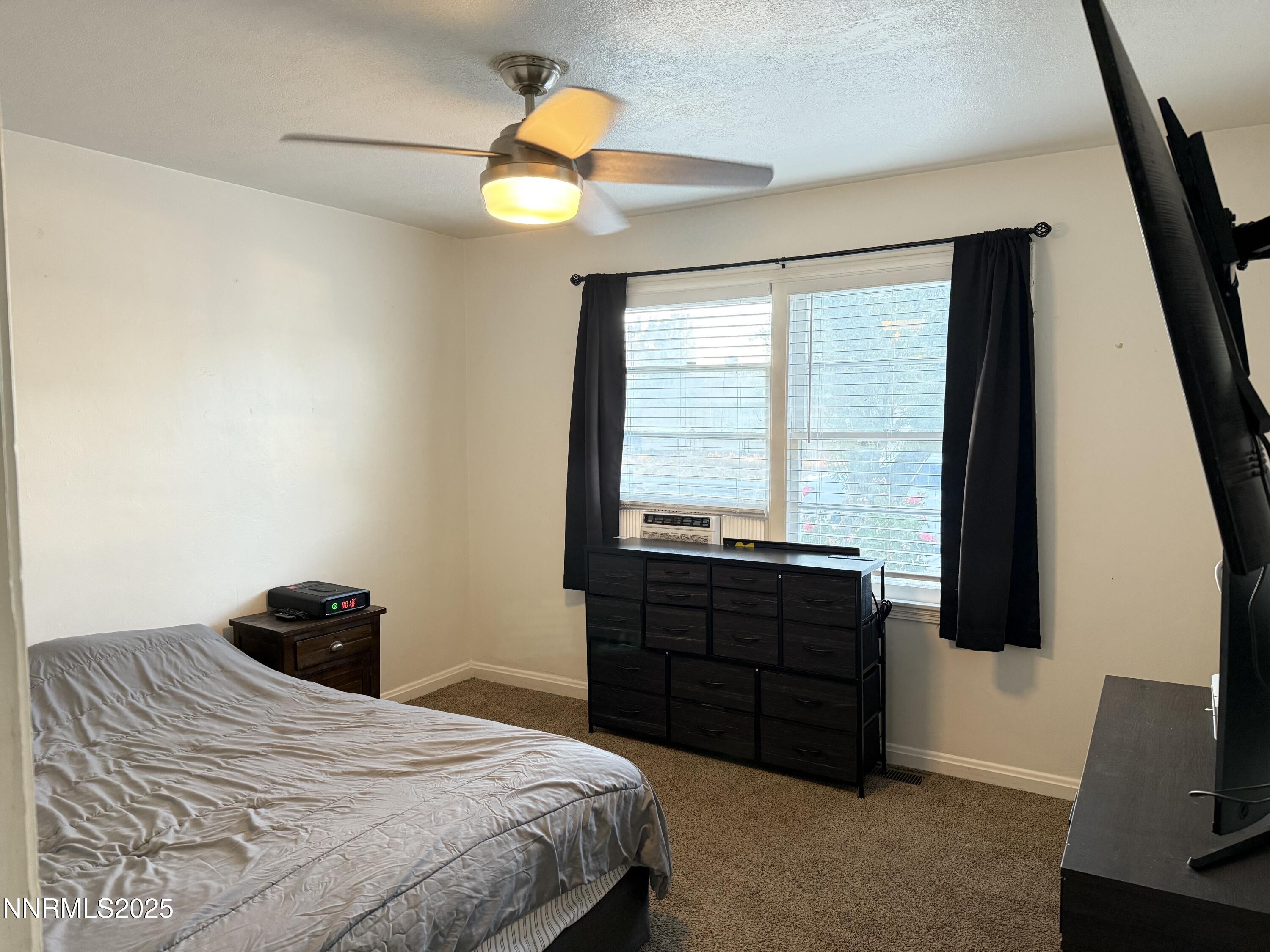 345 H Street Sparks, NV 89431 - Photo 13 of 14 a bedroom with a bed and a television
