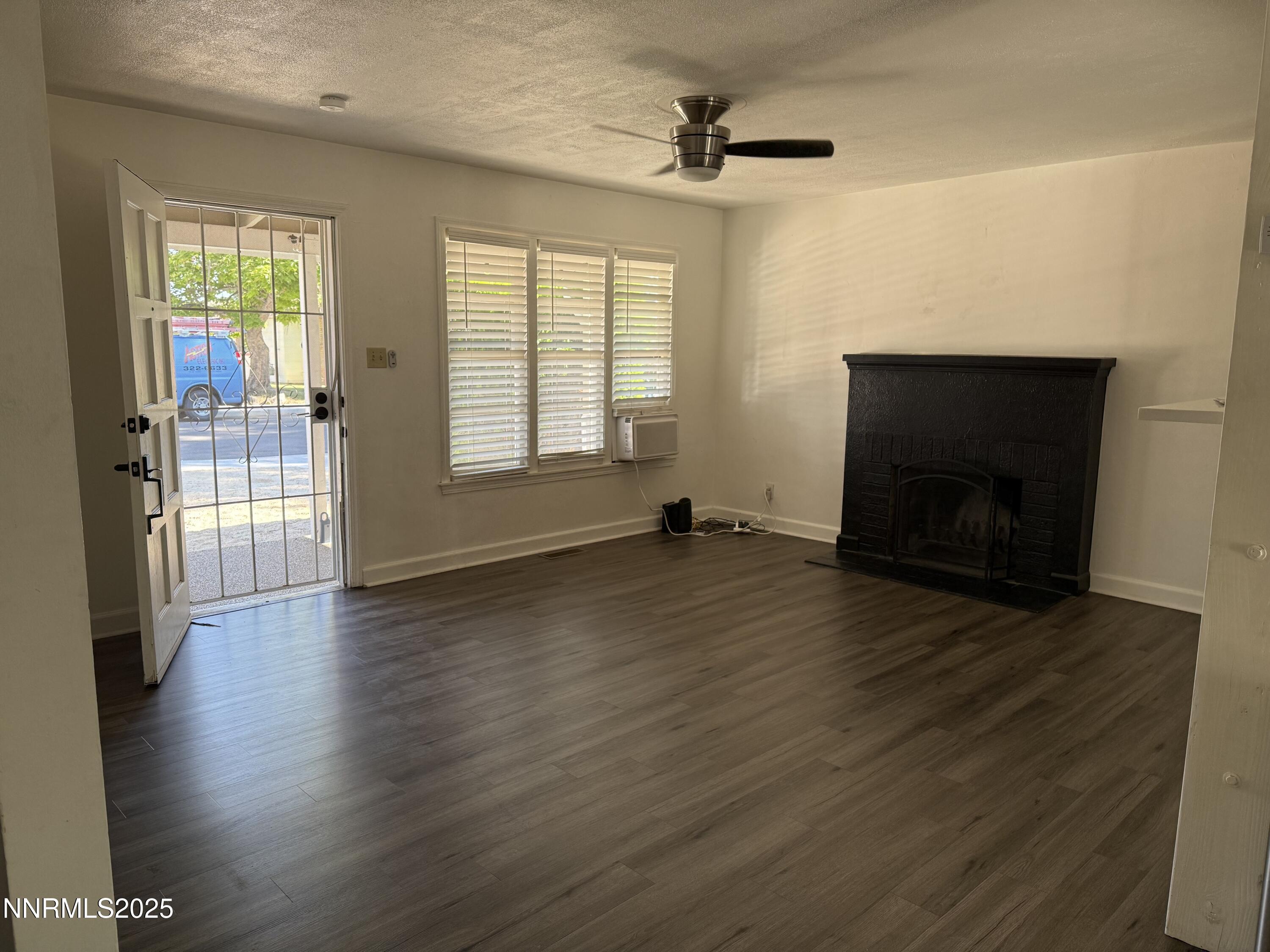 345 H Street Sparks, NV 89431 - Photo 6 of 14 an empty room with wooden floor and windows