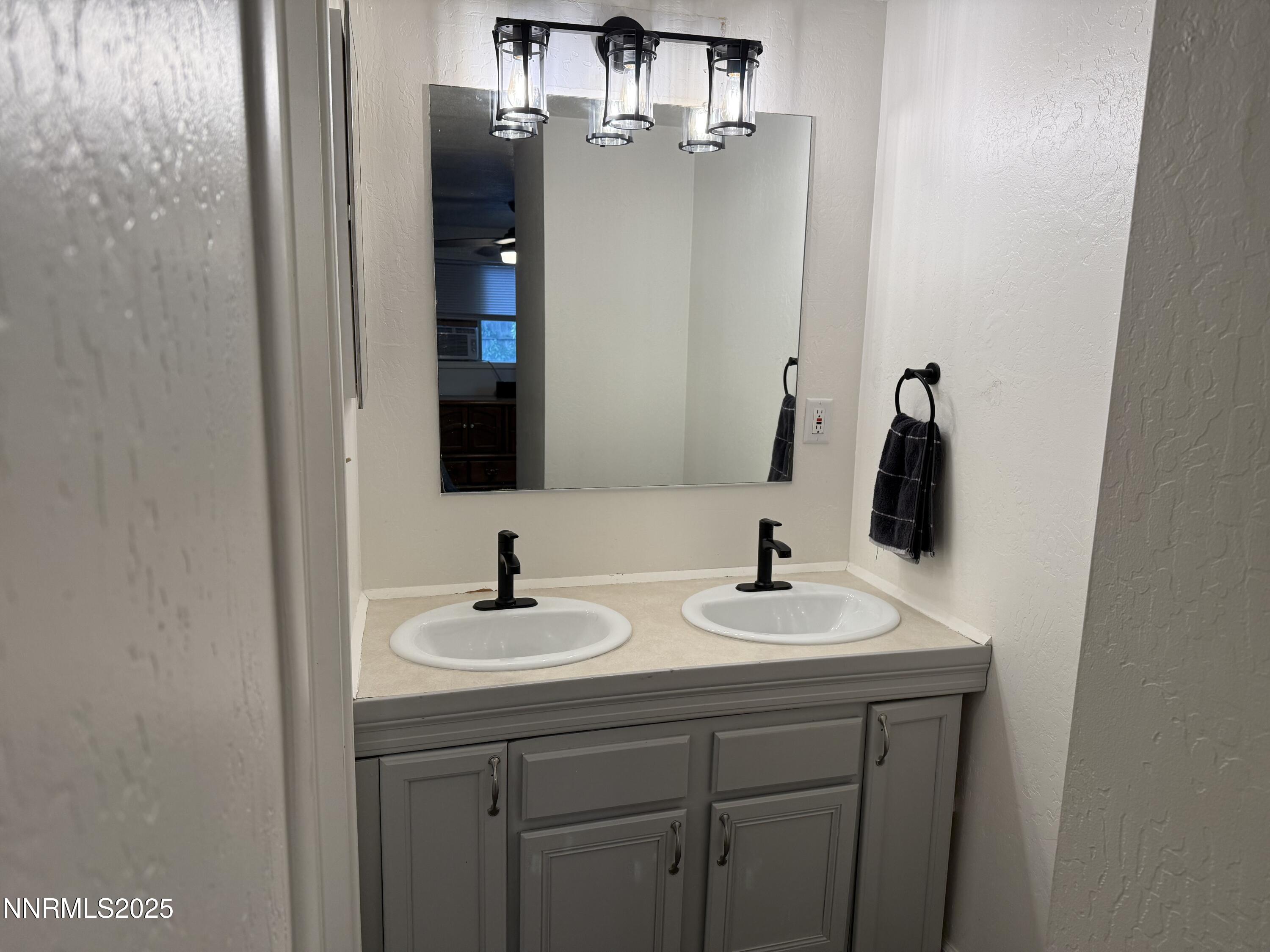 345 H Street Sparks, NV 89431 - Photo 7 of 14 a bathroom with a sink and a mirror