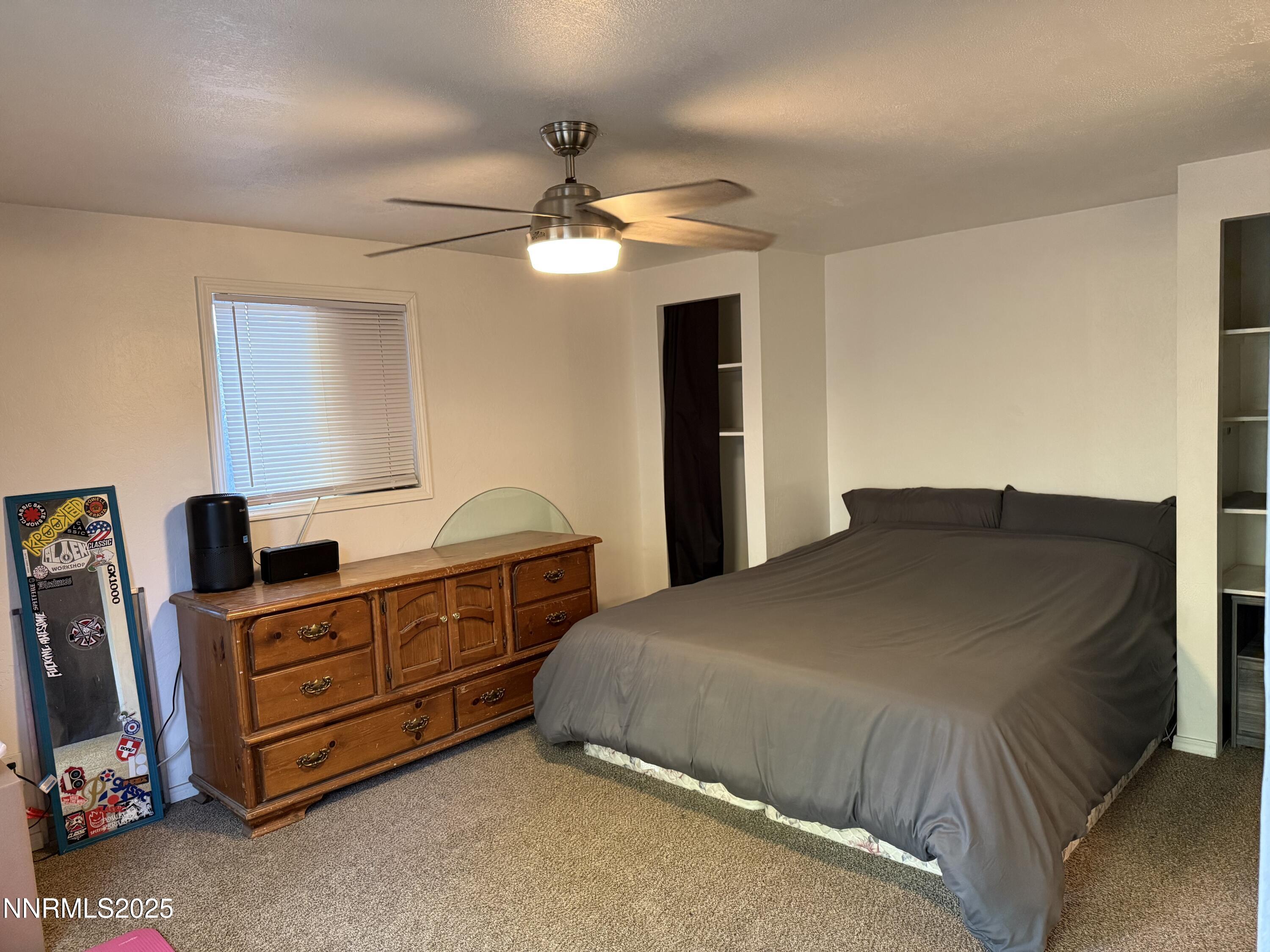 345 H Street Sparks, NV 89431 - Photo 9 of 14 a bedroom with a bed and a dresser
