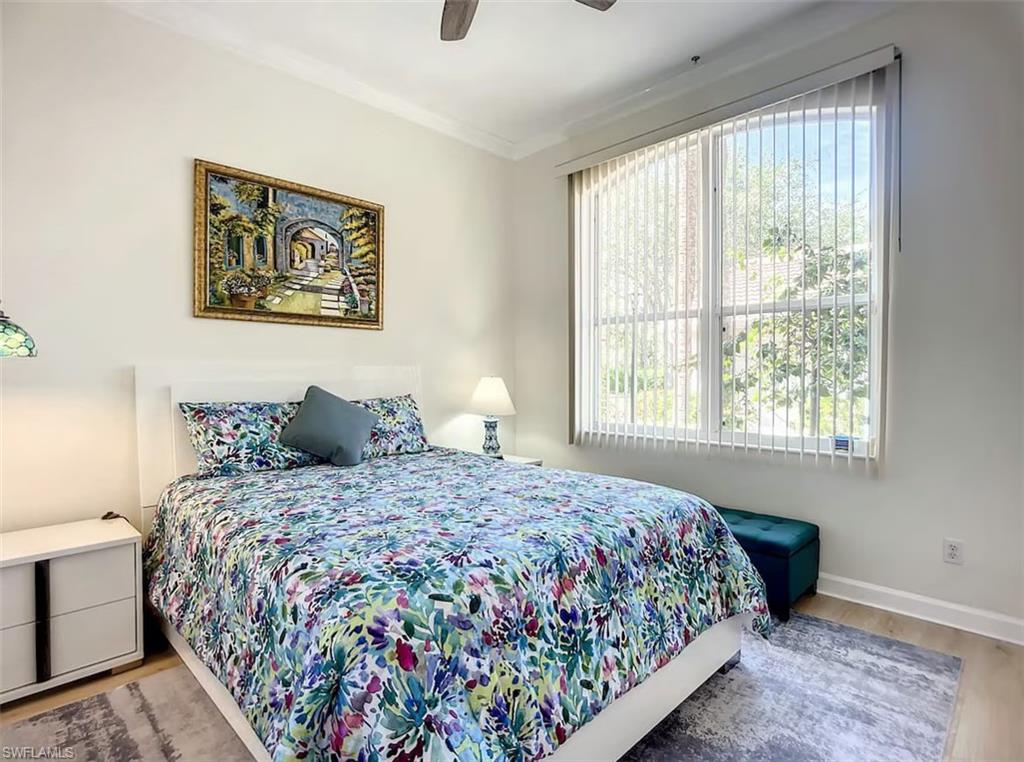 14530 Red Fox Run, Unit 215 Naples, FL 34110 - Photo 13 of 28 a bedroom with bed and a window