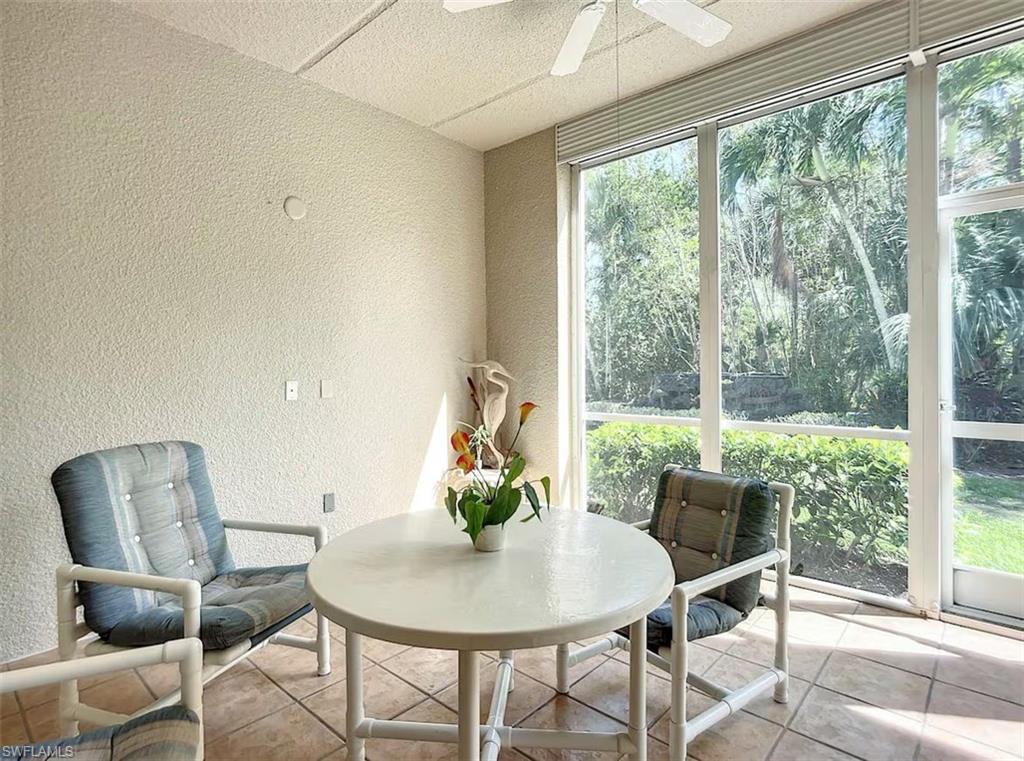 14530 Red Fox Run, Unit 215 Naples, FL 34110 - Photo 20 of 28 a view of a dining room with furniture window and outside view