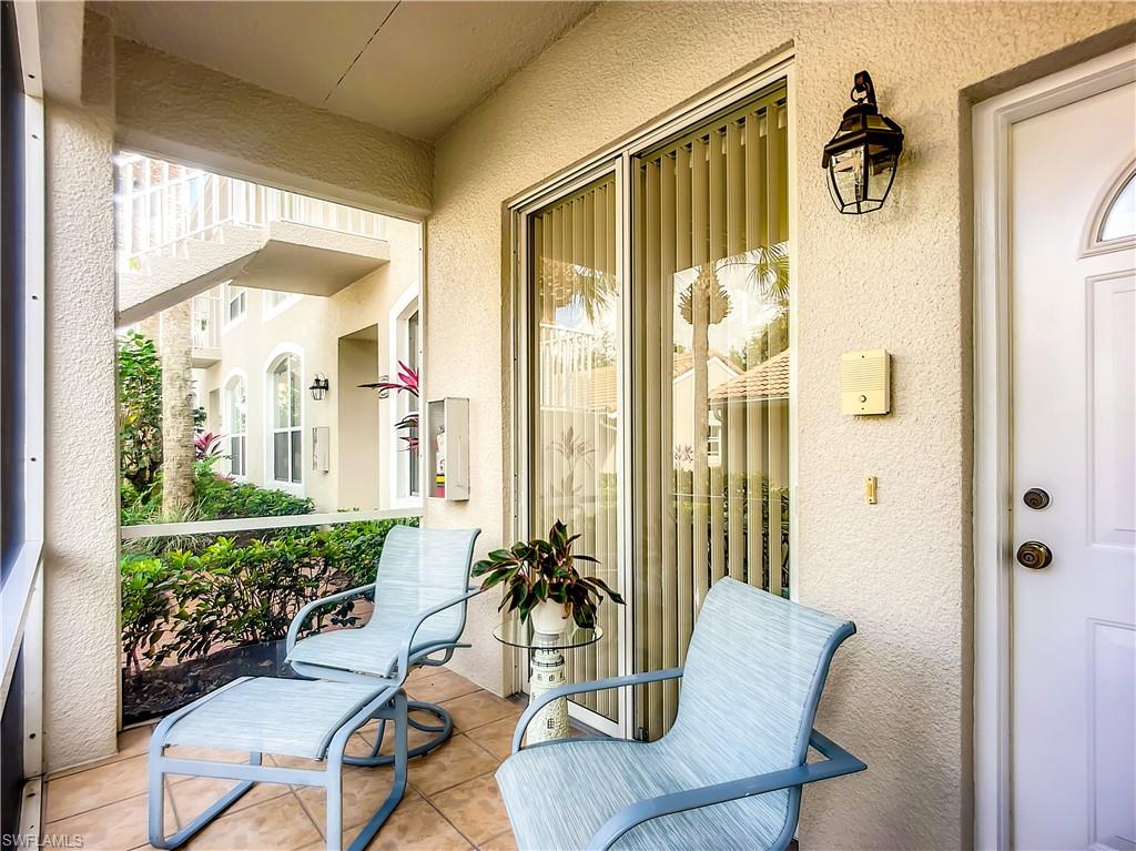 14530 Red Fox Run, Unit 215 Naples, FL 34110 - Photo 22 of 28 a living room with furniture and a large window
