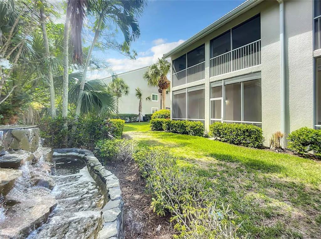 14530 Red Fox Run, Unit 215 Naples, FL 34110 - Photo 24 of 28 a view of a house with a yard