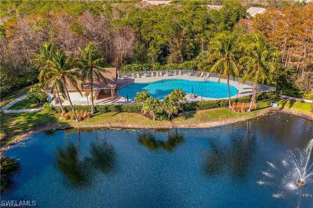 14530 Red Fox Run, Unit 215 Naples, FL 34110 - Photo 28 of 28 a view of a swimming pool with an outdoor space and seating area