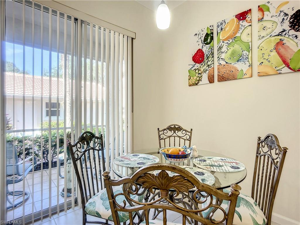 14530 Red Fox Run, Unit 215 Naples, FL 34110 - Photo 6 of 28 a view of a dining room with furniture window and outside view