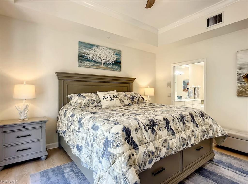 14530 Red Fox Run, Unit 215 Naples, FL 34110 - Photo 10 of 28 a bedroom with a bed and a night stand