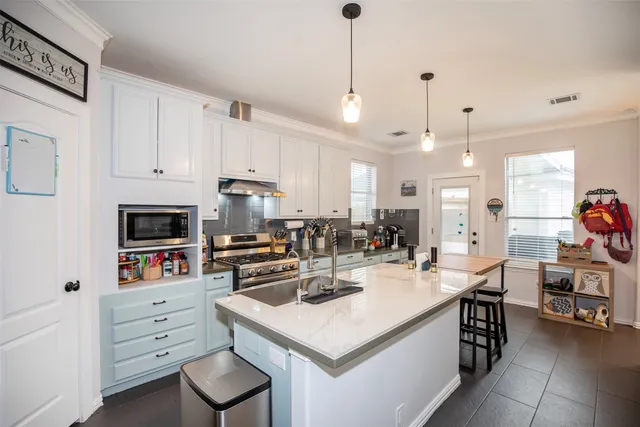 a kitchen with a stove a refrigerator and a sink