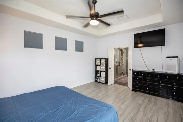 a view of living room with flat screen tv and wooden floor