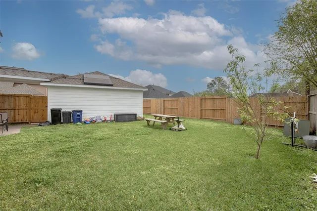 a backyard of a house with table and chairs
