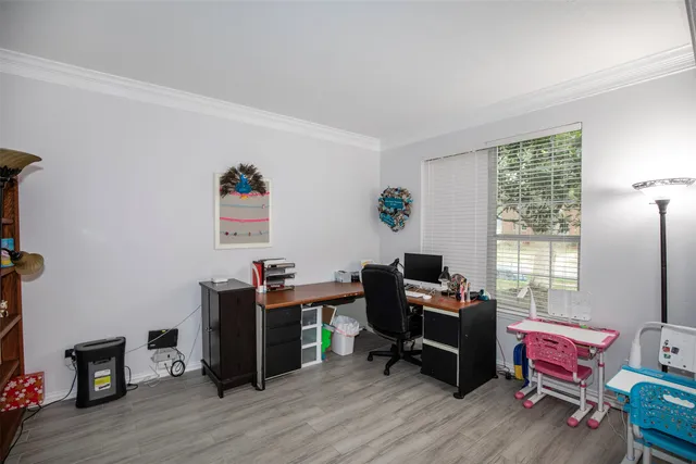 a view of a workspace with furniture and a window