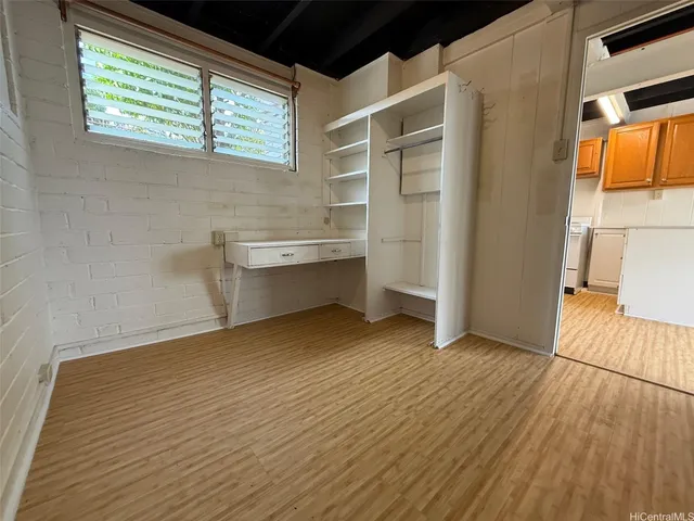 a view of a room with wooden floor and cabinet