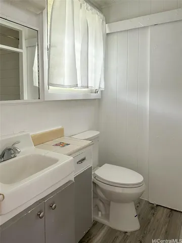 a bathroom with a sink a toilet and a mirror