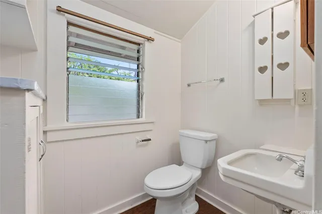 a white toilet sitting next to a bathroom sink