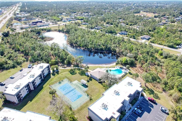 an aerial view of a house with a yard basket ball court