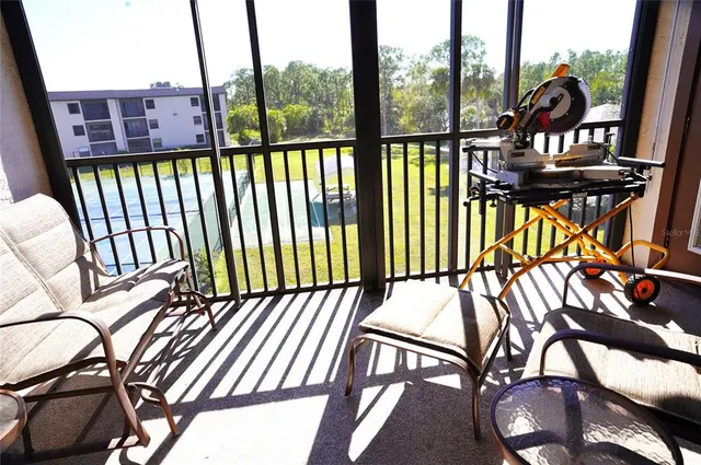 a view of a chairs and table in the balcony
