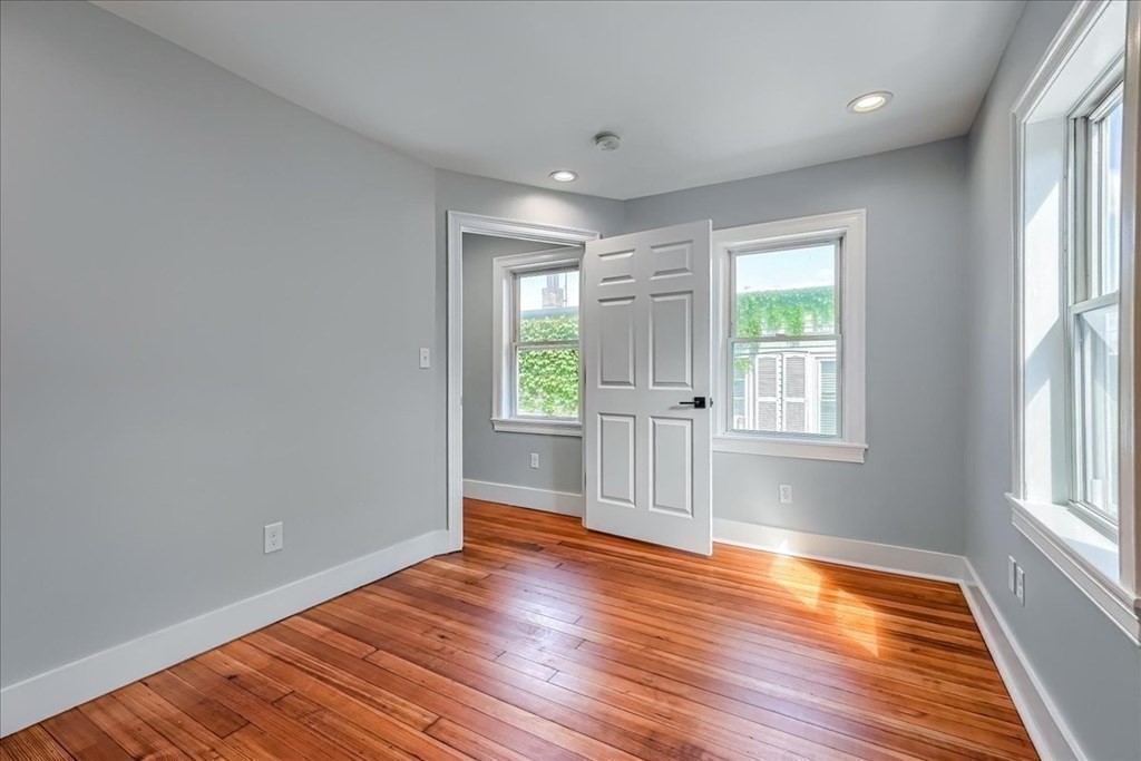 1 Short St Place Boston, MA 02129 - Photo 12 of 21 wooden floor in an empty room with a window