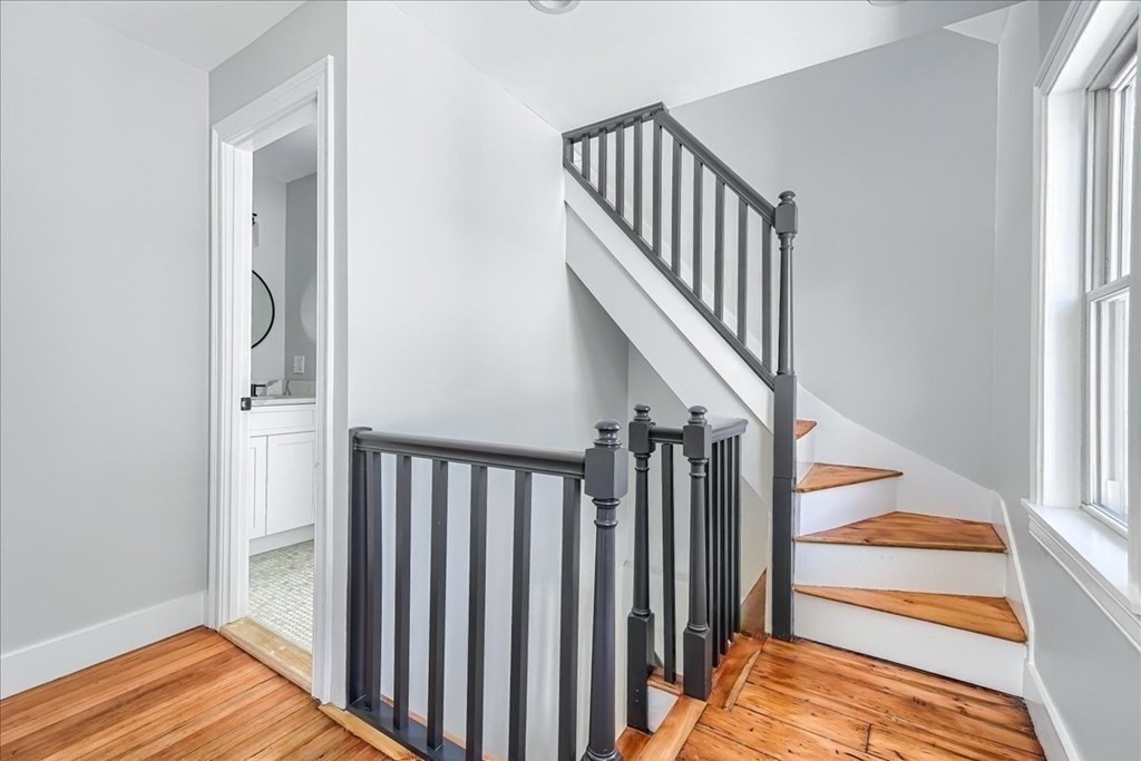 1 Short St Place Boston, MA 02129 - Photo 13 of 21 a view of a hallway with wooden floor and staircase