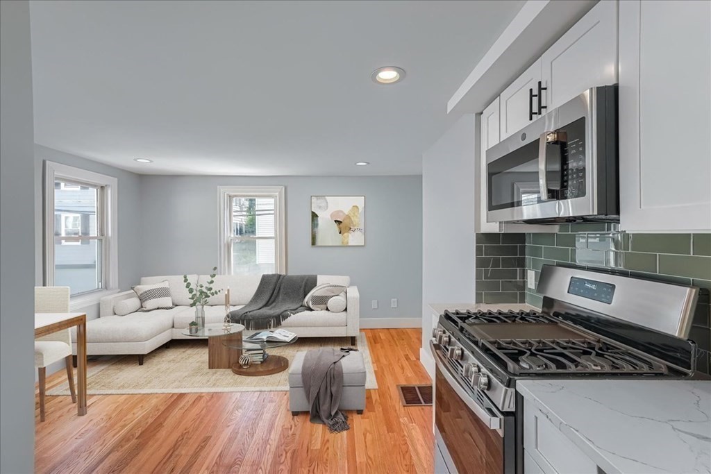 1 Short St Place Boston, MA 02129 - Photo 2 of 21 a living room with furniture and a wooden floor