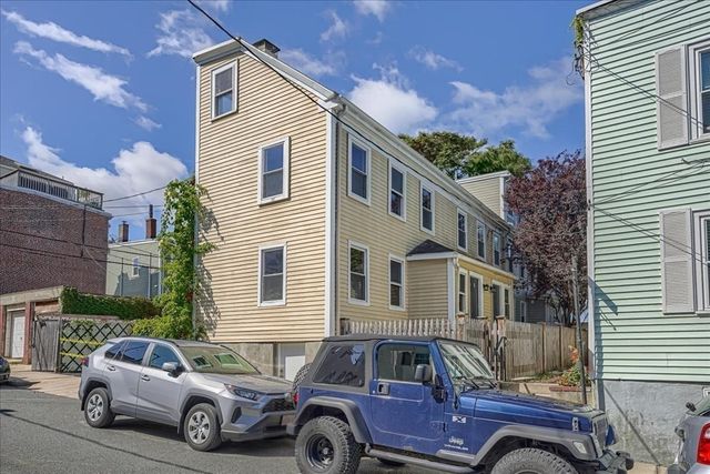 a front view of a house with parking space