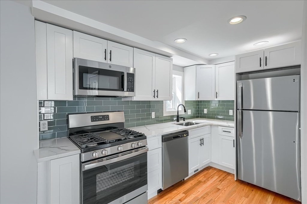 1 Short St Place Boston, MA 02129 - Photo 3 of 21 a kitchen with stainless steel appliances a stove microwave and sink