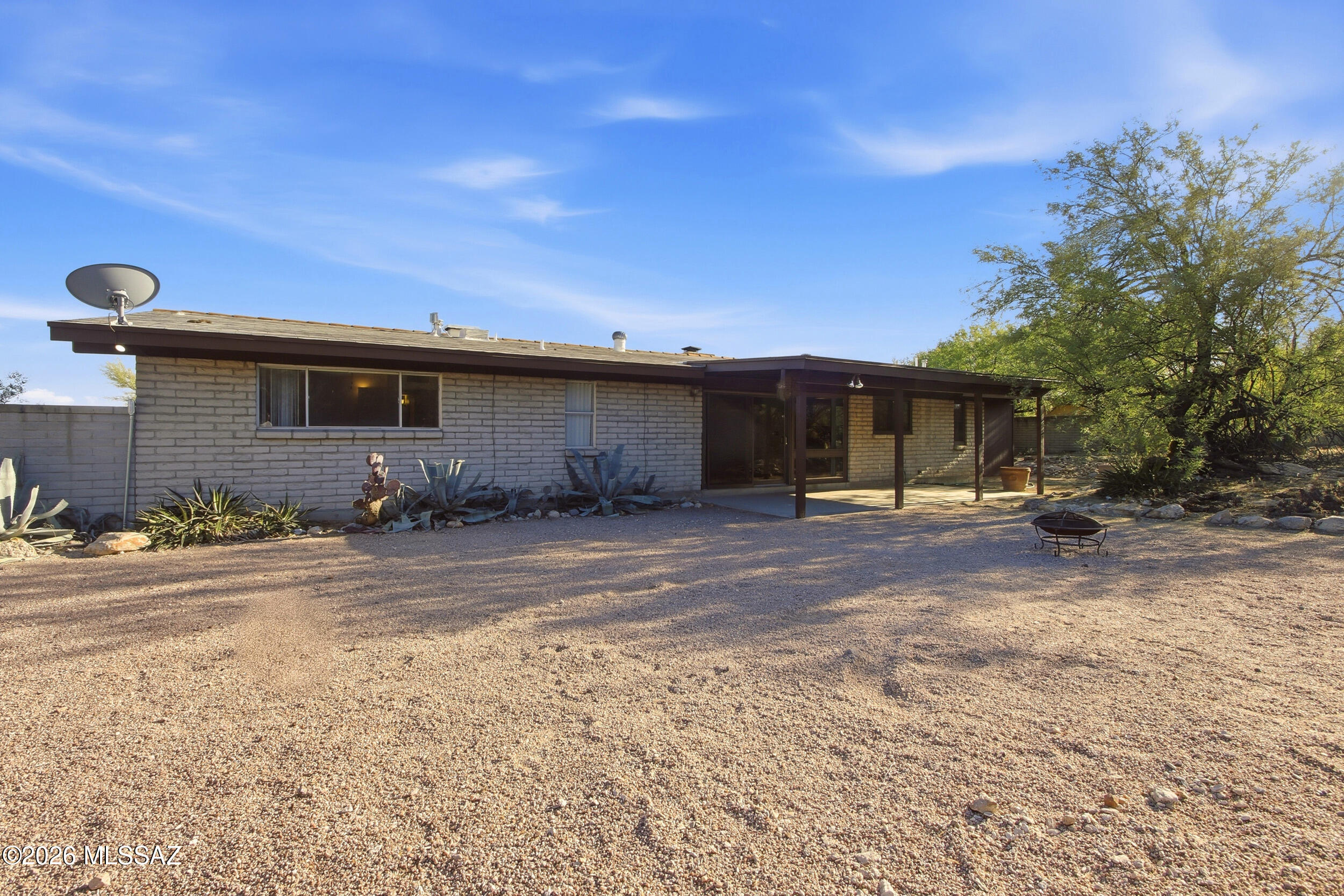 9141 East Indian Canyon Road Tucson, AZ 85749 - Photo 27 of 33 a front view of a house with a yard and garage