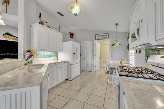 a kitchen with a sink stove and refrigerator