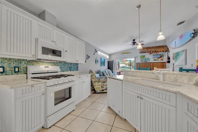 a kitchen with a stove cabinets and a fireplace