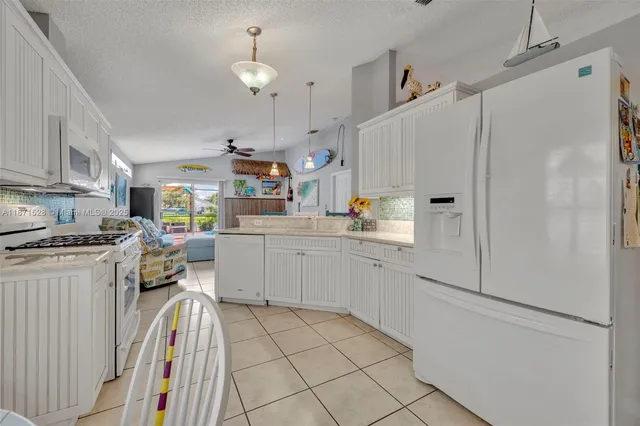 a kitchen with cabinets and appliances