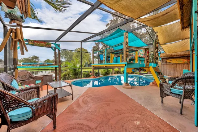 a view of a swimming pool with a porch and furniture