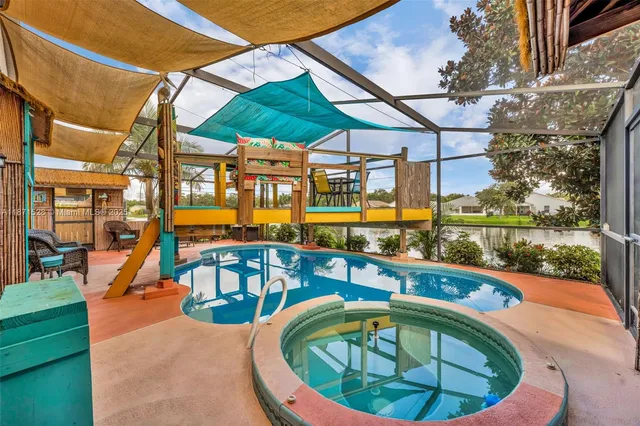 a front view of a house with swimming pool outdoor seating