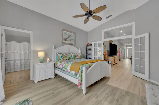 a bedroom with a large bed and a chandelier