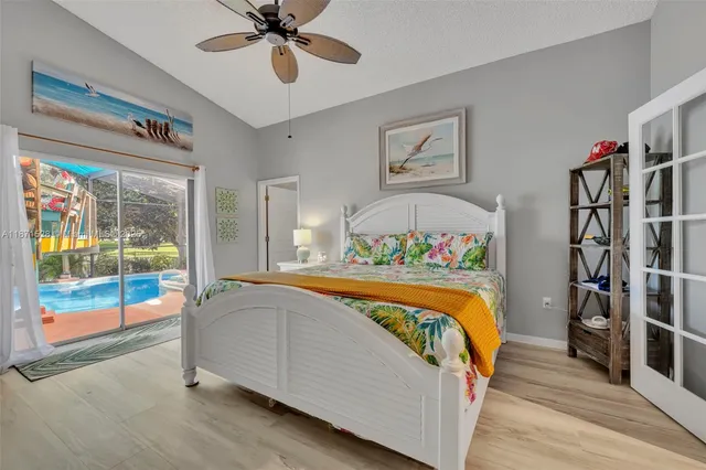 a bedroom with bed and a chandelier