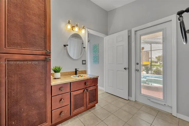 a spacious bathroom with a granite countertop sink a mirror and a shower