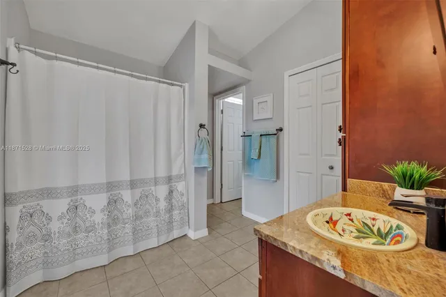 a spacious bathroom with a granite countertop tub sink and shower