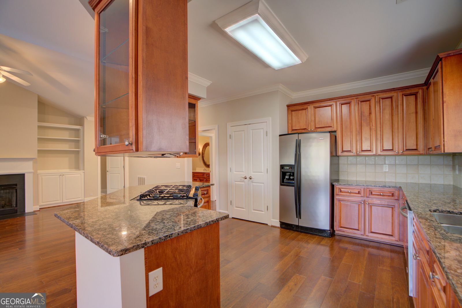 115 Carriage Way Southeast Rome, GA 30161 - Photo 12 of 39 a kitchen with granite countertop a refrigerator a stove and a wooden floors
