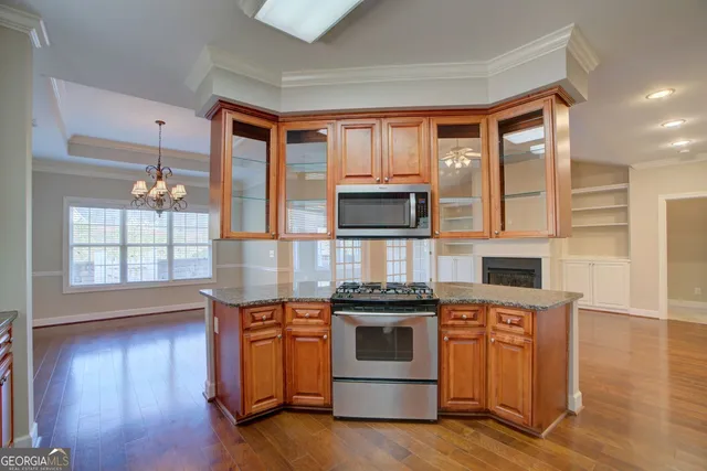 a kitchen with stainless steel appliances granite countertop a stove and a microwave