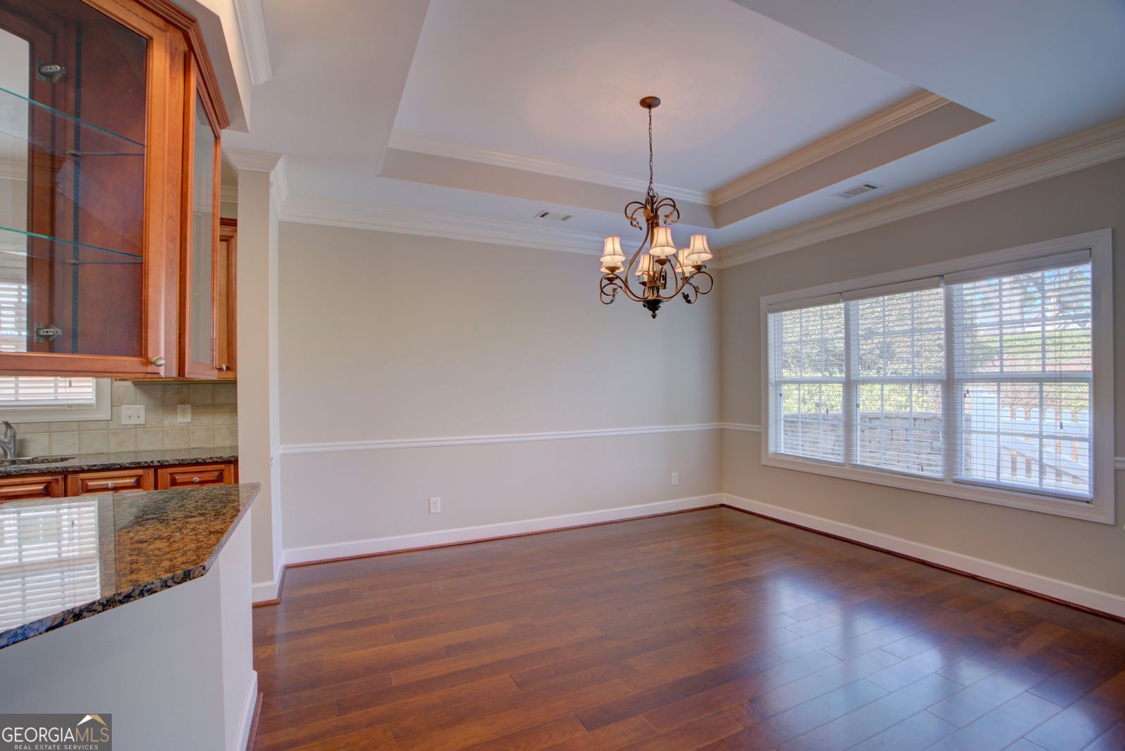 115 Carriage Way Southeast Rome, GA 30161 - Photo 14 of 39 a view of an empty room with wooden floor and a window