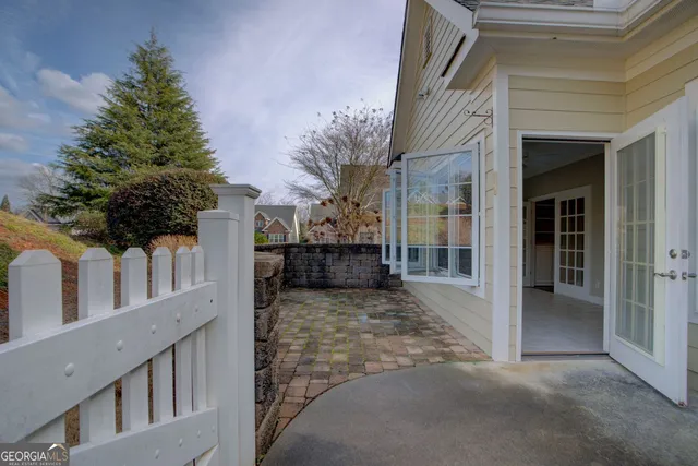 a view of a house with a large windows and yard